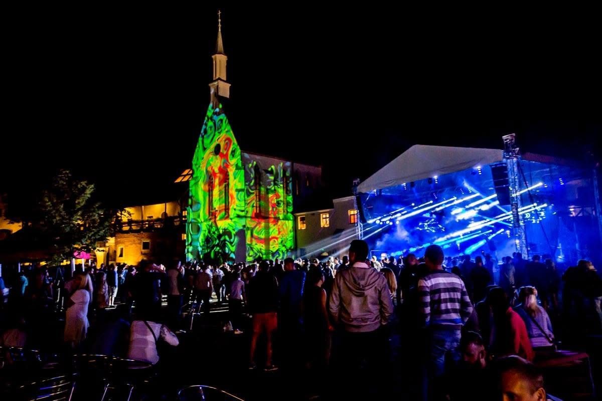 Noční festivalový dav, projekce na kostele